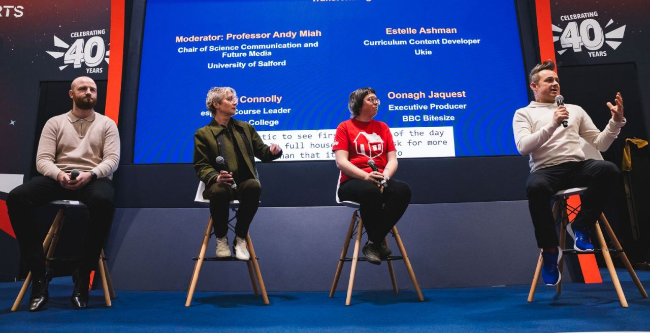Panel of professional experts sitting on stools having a discussion at an event