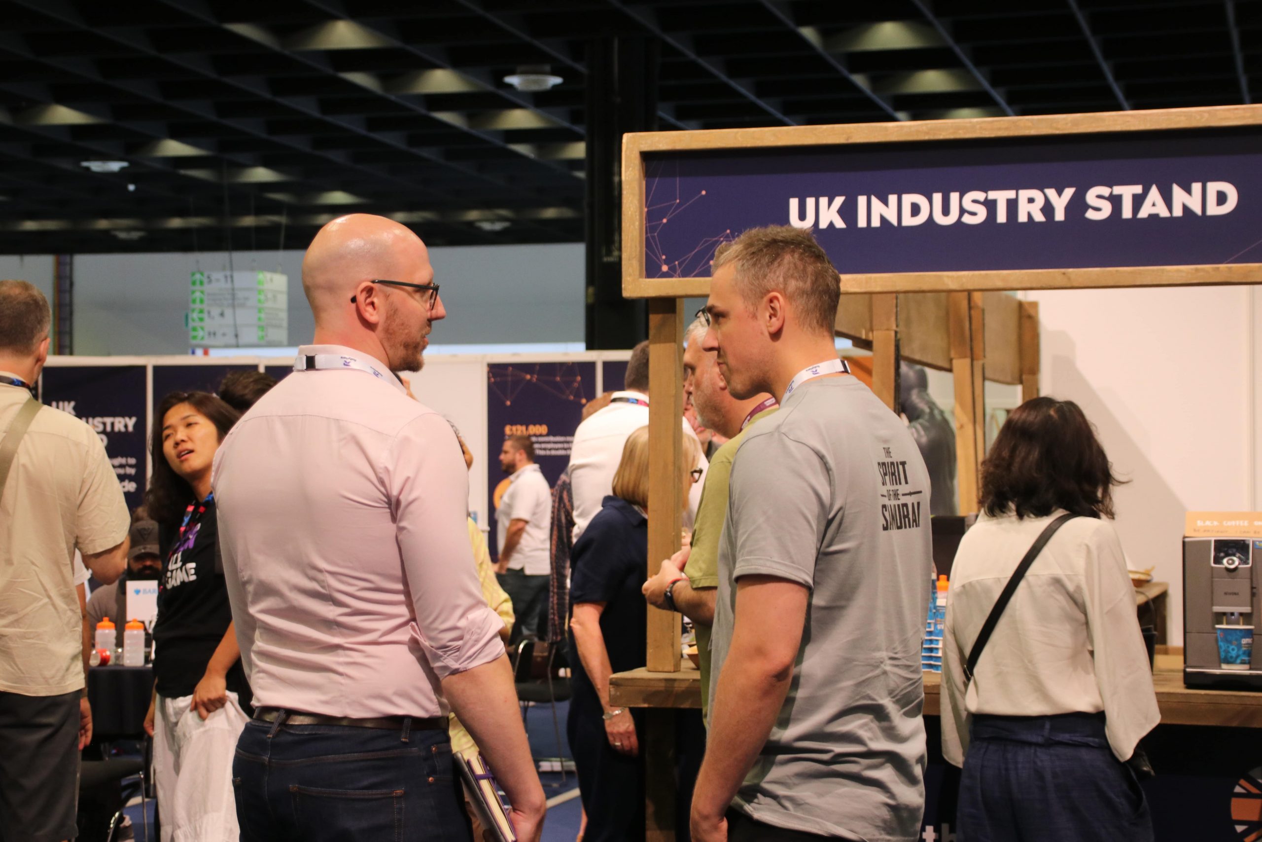 Professional standing around a UK industry Stand at a networking event