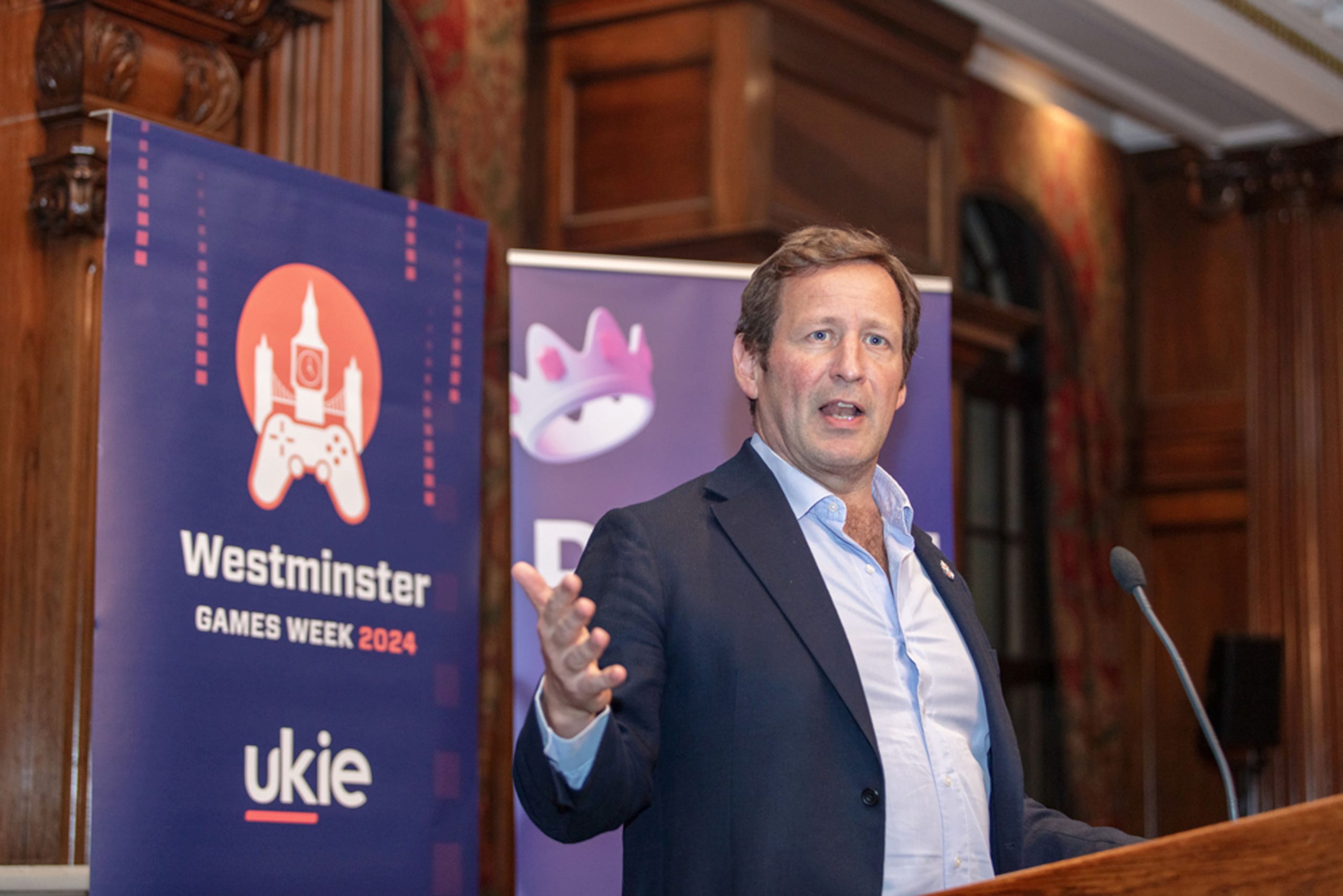 Professional man giving a speech at a lectern at Westminster Games Week 2024