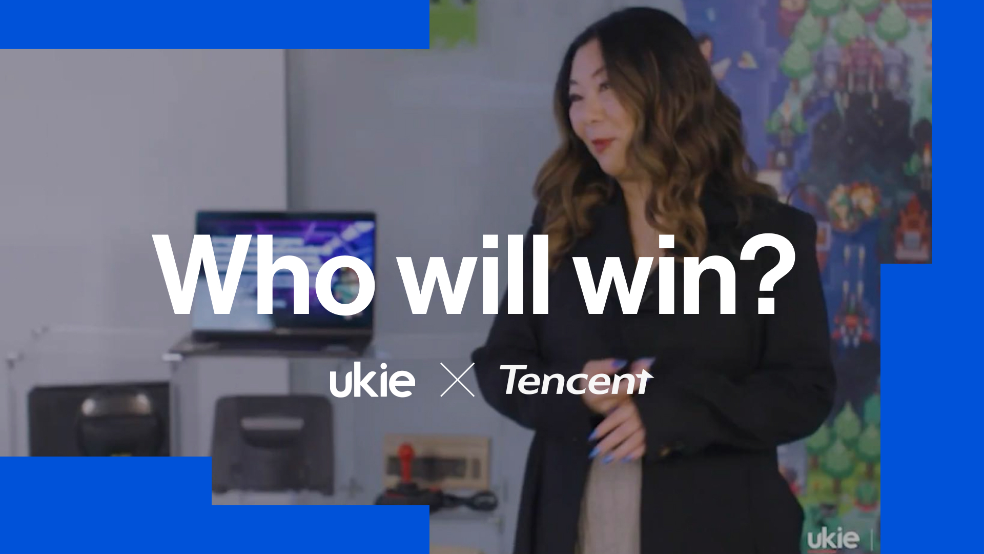 Ukie graphic with text 'Who will win?' with a long haired woman wearing a black blazer in the background with computer hardware