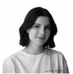 Black and white image of a woman with short, cropped hair smiling at the camera. She's called Anna Kozlova