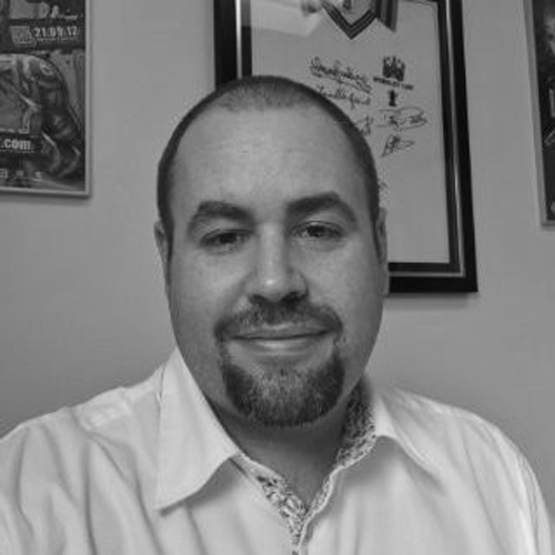 Black and white image of a bearded man wearing a white shirt called David Gould