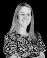 Black and white headshot of women wearing a patterned top smiling called Samantha Ebelthite